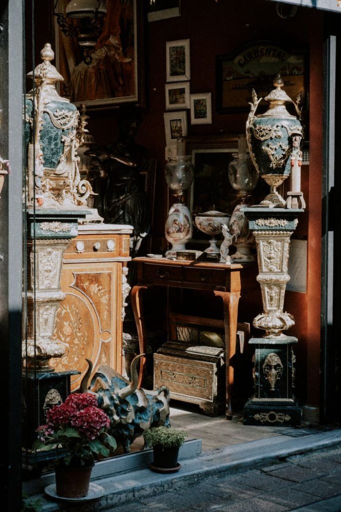 Explore a quaint antique shop showcasing ornate vases and vintage decor in a cozy setting.