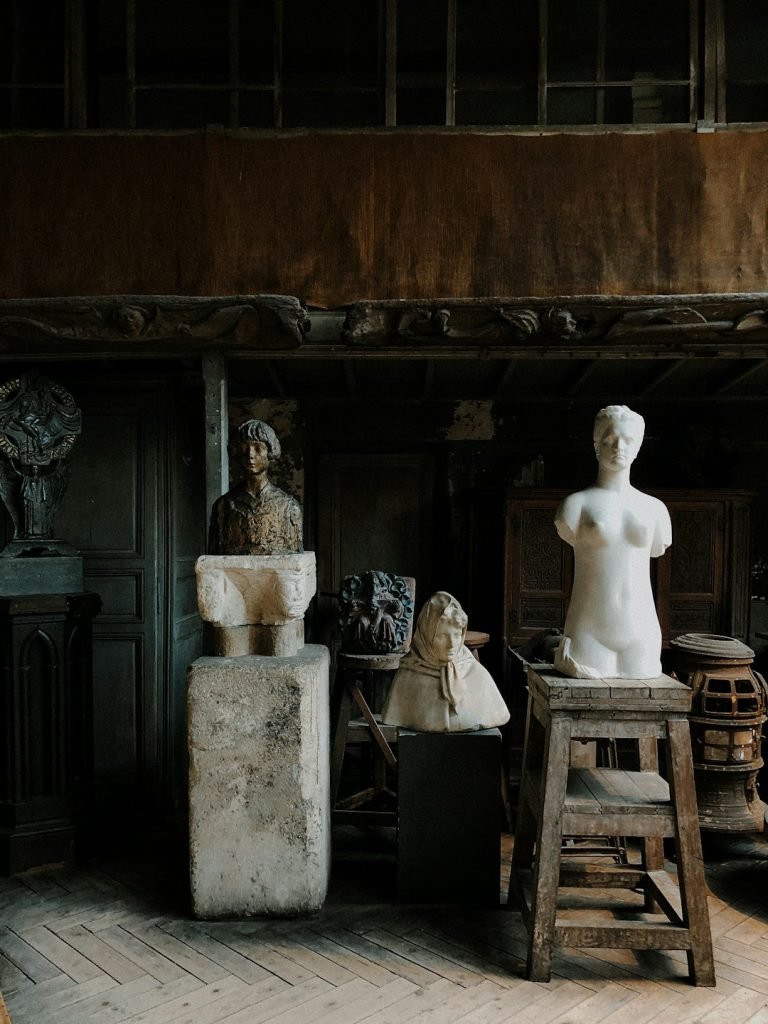 white-ceramic-statue-on-brown-wooden-table-cyesixvikfs